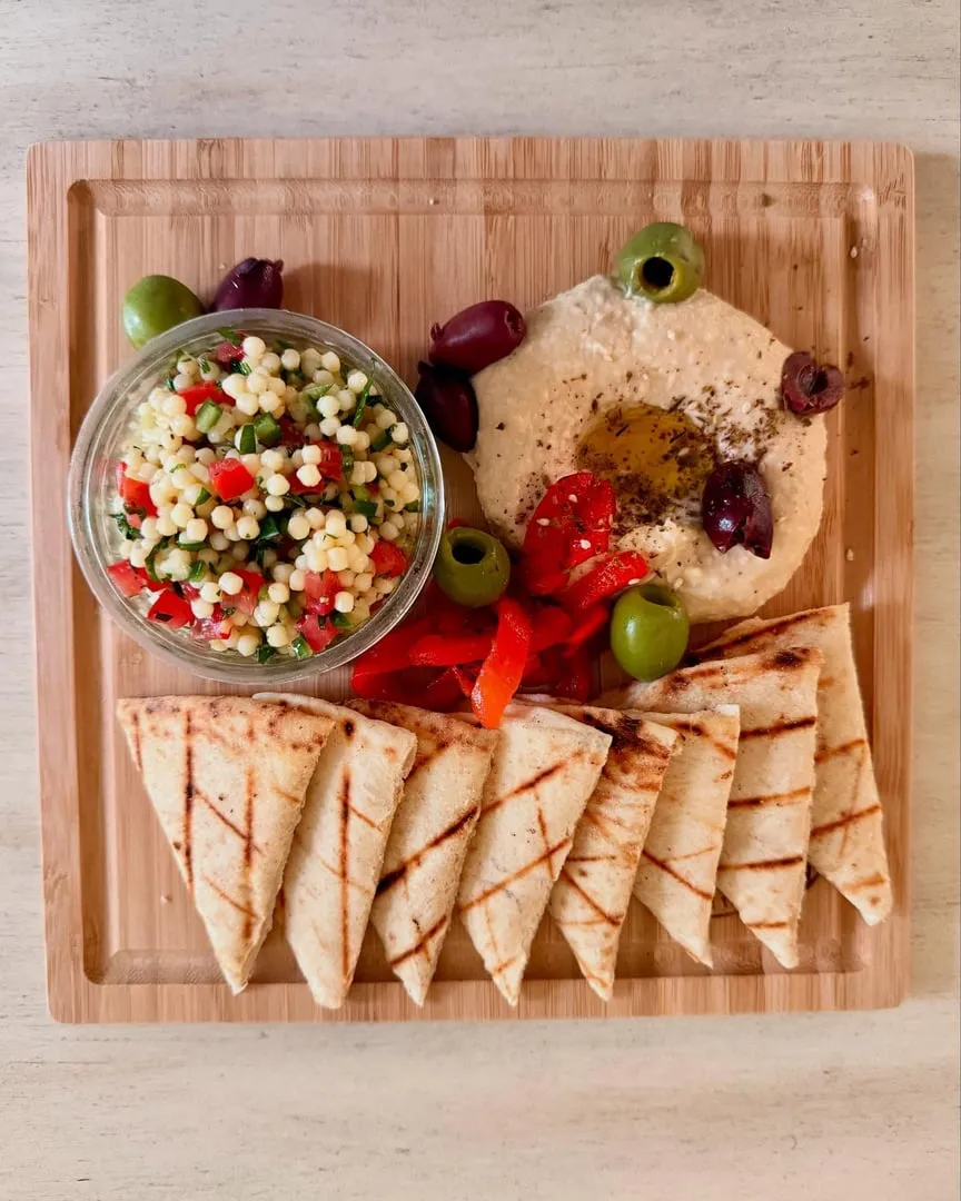 The Akres mezze platter: hummus, tzatziki, olives and stuffed grape leaves with grilled pita